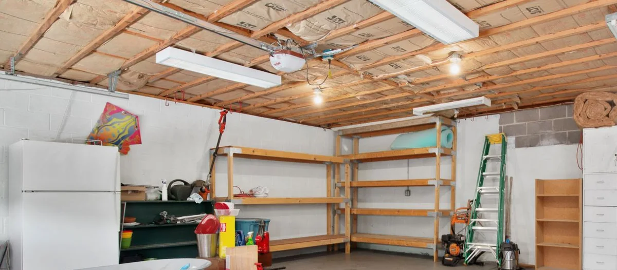 Garage door opener head unit and rail mounted between insulated ceiling joists
