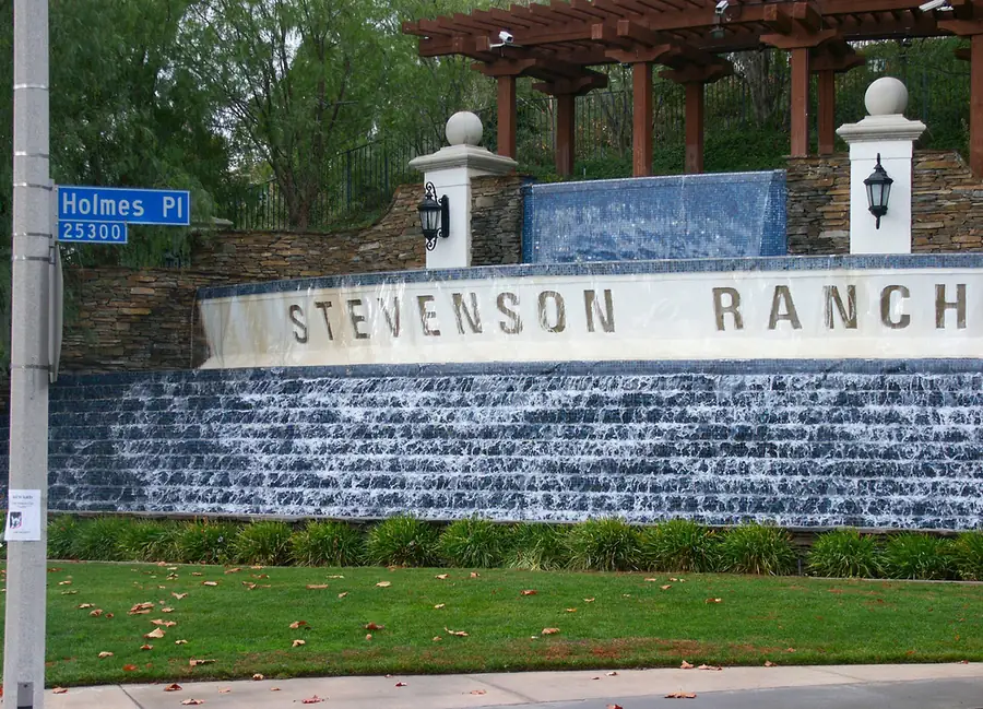 Stone and water-wall community entrance monument with a water wall